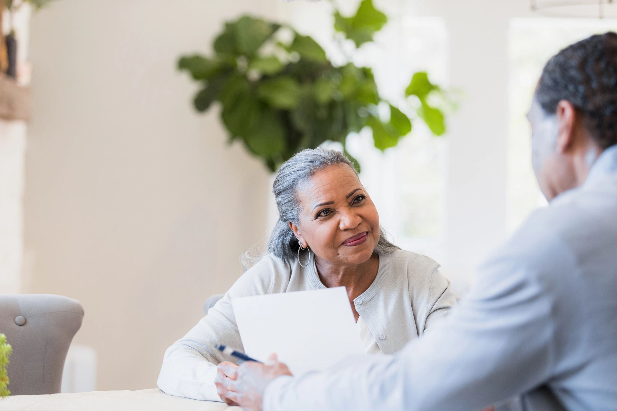 Insurance advisor meeting with a senior client